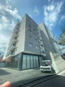 a building with a car parked in front of it at Apartment for rent in Deçan in Deçan