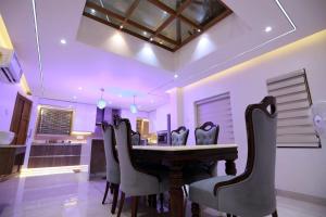 a dining room with a table and chairs at Thekkumbath Sea Breeze Pool villa in Kannur