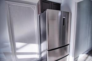 a stainless steel refrigerator in the corner of a kitchen at Large and beautiful master room with private bathroom in Vaughan