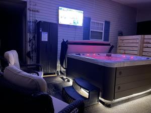 a room with a hot tub with lights in it at Twin Ponds Retreats retreat in Whittier
