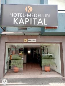 a hotel melchin kapital sign on the front of a building at Hotel Medellin Kapital in Medellín