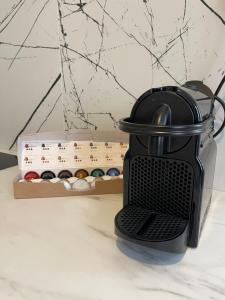 a black coffee maker sitting on a counter next to a box ofuclearuclearuclear at Suite Carter in Lyon