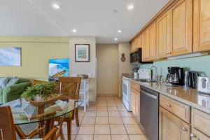 a kitchen with a table and a dining room at Kaanapali Shores 640 in Kahana
