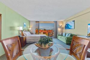 a room with a living room with a bed and a couch at Kaanapali Shores 640 in Kahana