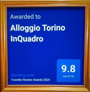 a framed sign for an albuquerque tumor in induador at Alloggio Torino InQuadro in Turin
