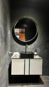 een badkamer met een wastafel en een spiegel bij Люкс в стиле LOFT in Pavlodar
