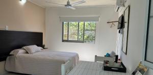 a bedroom with a bed and a window at La Pilar in Formosa