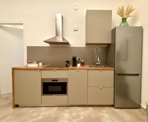 a kitchen with a sink and a refrigerator at La Cadrega in Milan