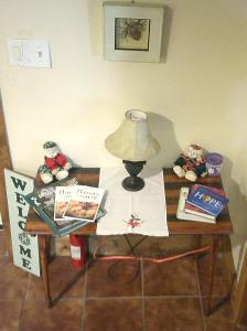 a table with a lamp and books on it at Lil Black Bear Inn in Nashville