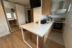 a kitchen with a white counter top in a room at Captivating apartment with all amenities in Bordeaux