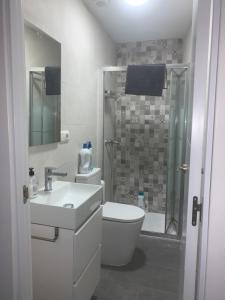 a bathroom with a toilet and a sink and a shower at La Joya de la Caleta. A 60 mts playa. in Cádiz