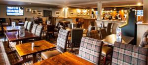 a restaurant with tables and chairs and a bar at Moffat Manor Holiday Resort in Beattock