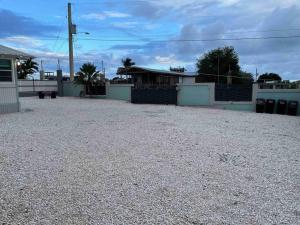 a large gravel parking lot in front of a house at Peaceful Oasis near Combate Beach in Cabo Rojo
