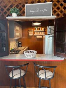 two chairs sitting at a counter in a kitchen at Peaceful Oasis near Combate Beach in Cabo Rojo