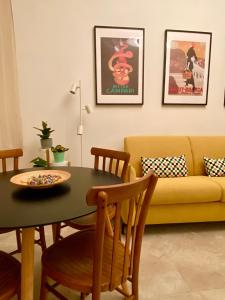 a living room with a table and a yellow couch at La Cadrega in Milan