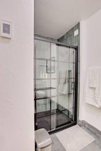 a bathroom with a glass shower with a toilet at Slope Side Studio in Northstar Village! in Truckee