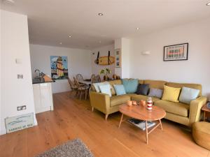 a living room with a couch and a table at 3 Bed in Ilfracombe 42432 in Ilfracombe