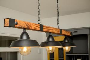 a group of lights hanging from a wooden beam at Urban Oasis Apartments at Hidas in Windhoek