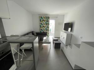 a living room with a couch and a table at Isis House in Maspalomas