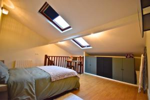 a bedroom with a bed and two skylights in the ceiling at Tour Pleyel - Duplex Lumineux in Saint-Denis