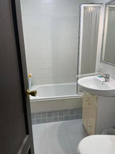 a bathroom with a tub and a sink and a toilet at At Moustapha in San Juan de Aznalfarache