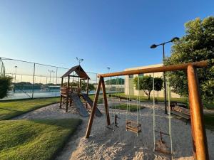 a park with a playground with a swing at Lindo Flat no Carneiros Beach Resort in Tamandaré