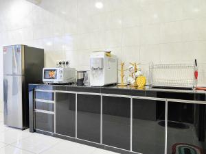 a kitchen with a counter with appliances on it at Bukit Indah, Pool Table, 16Pax, 5 min to Aeon mall in Johor Bahru