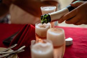 Sennecey-le-GrandにあるAuberg'Innのシャンパンをテーブルの上に注いでいる人