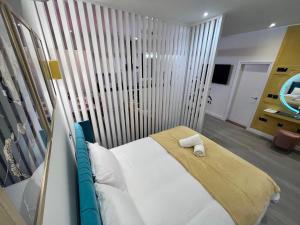 a bedroom with a bed and a mirror in it at Stylish Studio in Colchester