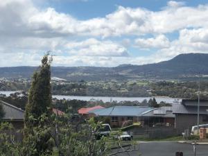a view of a river and a town with a lake at Sunshine Apartment in Austins Ferry