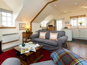 a living room with a couch and a table at 1 bed in Shipston-on-Stour CC011 in Cherington