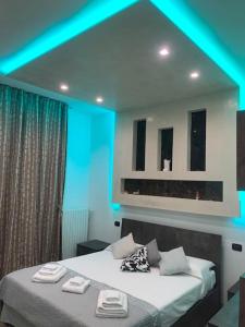 a bedroom with a bed with blue lights on it at Appartamento Luxury Adri in Talignano