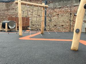 a swing set in a room with a brick wall at Wygodne Mieszkania Nova Mikołowska 98 in Katowice +4 photos