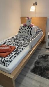 a bed with a stuffed animal sitting on top of it at Fogarasi - Relax Island in Budapest