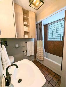 a bathroom with a white sink and a shower at Charming Home on Callahan in Tyler