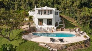 an aerial view of a house with a swimming pool at WALD HAUS by DW in Naguabo