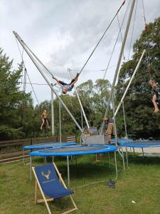 a group of people swinging on a trampoline at Gościnna Chata in Jaworki