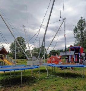 a play park with swings and a playground at Gościnna Chata in Jaworki