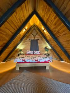 a bed in the middle of a room in a attic at bungalow in Sinop