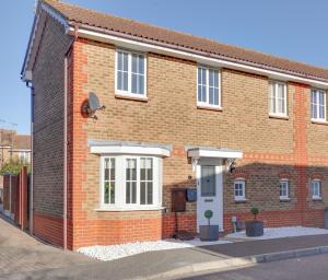 a brick house with white windows on a street at Cosy 2 bedroom house - With Free Parking and Wifi in Chelmsford