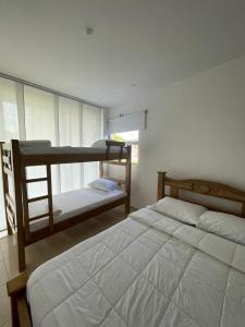 a bedroom with two bunk beds and a window at Casa zumar in Coveñas