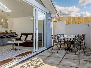 a patio with a table and chairs and a couch at 2 Bed in Brixham 90912 in Brixham