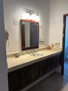 a bathroom with a sink and a mirror at 15 - 139 B Stunning Oceanview Dept in Los Tules in Puerto Vallarta