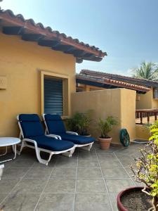 two chairs and a table on a patio at 15 - 139 B Stunning Oceanview Dept in Los Tules in Puerto Vallarta