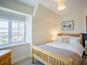 a bedroom with a large bed and a window at 3 Bed in Craster 79436 in Craster