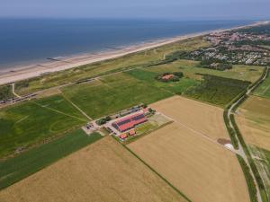 an aerial view of a farm and the ocean at Hof Babel in Domburg