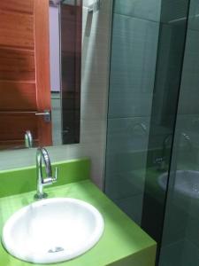 a bathroom with a sink and a glass shower at Suite star in Duque de Caxias