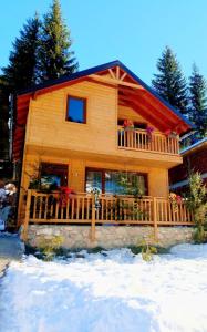 a log cabin with snow in front of it at Villat Kroni Boge Rugove in Boge