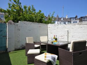 a patio with a table and chairs and a fence at 4 Bed in Brixham 90449 in Brixham