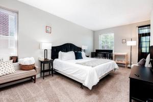 a bedroom with a large bed and a couch at 3 King Beds/3Baths Spacious in Soulard